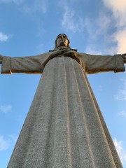 A statue of Cristo Rey and a view of the bridge named April 25 in Lisbon, Portugal.