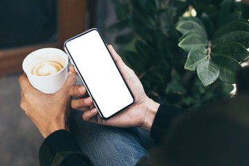 cell phone mockup image blank white screen.woman hand holding texting using mobile on desk at coffee shop.background empty space for advertise.work people contact marketing business,technology