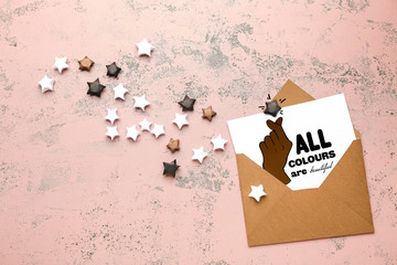 Different paper stars with envelope on color background. Racism concept