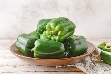 Plate with green bell pepper on table