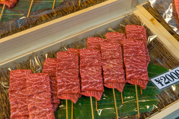 Wagyu beef skewer marinated in black pepper prepare to sell to customer in Tsukiji Fish market.