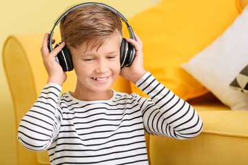 Little boy listening to music at home