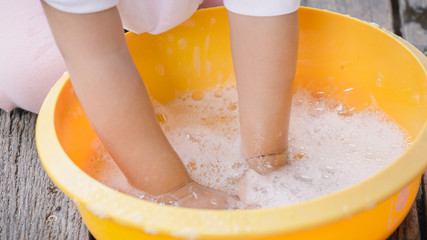 Child washing hands with soap to prevent virus and bacteria for corona virus (covid19) protection.