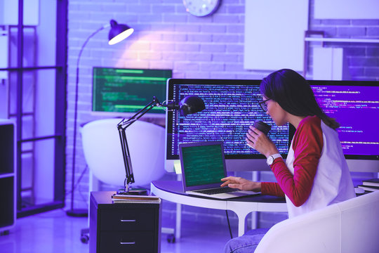 Female programmer working in office at night