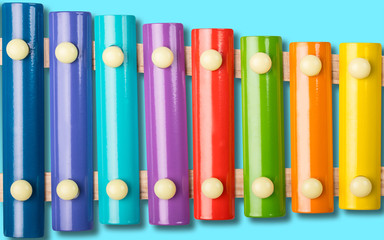 Xylophone on blue background. Rainbow colors. Colour xylophone. Colorful musical instrument for children or kid