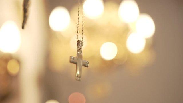 Βaptismal cross in church with bokeh close up