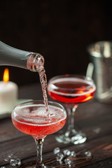 Two glasses of  champagne on dark wooden background. Festive drink. Valentins or Christmas concept.