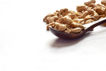 Closeup of Cashew Nuts in a wooden spoon isolated on the white background, Full depth of field.
