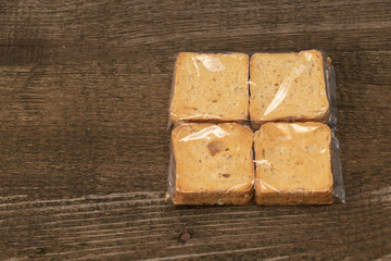 Tasty rusks on wooden background. packaged with copy space