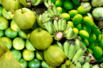 Fresh Collection Fruits Background, from left to right, grapefruit, oranges, guava, bananas, mango, coconut