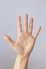 The hand shows the number five. Countdown gesture or sign. Sign language.
