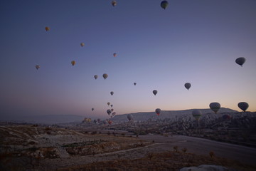 Hot air balloon flying over rock landscape at Cappadocia Turkey