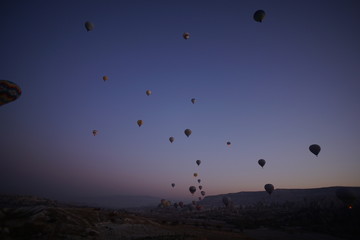 Hot air balloon flying over rock landscape at Cappadocia Turkey