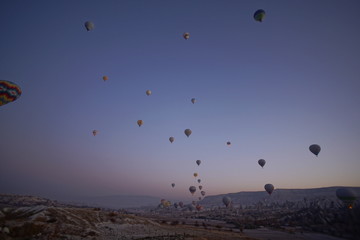 Hot air balloon flying over rock landscape at Cappadocia Turkey