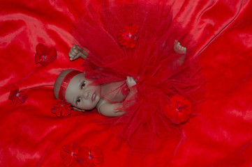 the reborn ethnic doll on a red background