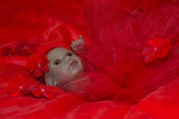 Reborn doll portrait, in red background