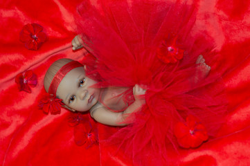 Reborn baby doll in red little tulle dress