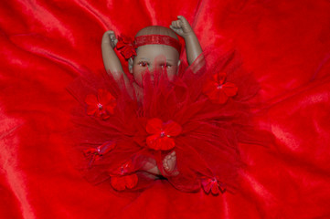 realistic newborn baby doll in red dress