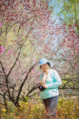 Fototapeta premium Portrait of happy senior beautiful woman in spring park 