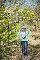 Portrait of happy senior beautiful woman in spring park 