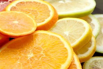 Grapefruit, Orange, lime, tangerine, lemon slices. The background is made of citrus fruits. Slices of citrus. The background of multi-colored citrus fruits. . Texture. Wallpapers. Vitamins
