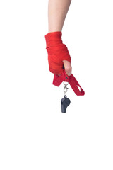black whistle on a red ribbon, for giving the command, in the hand, on a white background, there is...