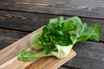 Bok choy or Chinese-cabbage on wooden board and wooden floor..Bok choy is the best leafy green vegetable.