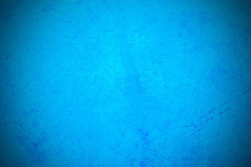 Blue background, Old blue smooth plaster wall with crack for background, Old blue wall, vignette, slightly brighten the center of the image for filling letters, an abstract concept for the background.