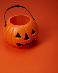 Jack o lantern pumpkin on orange background