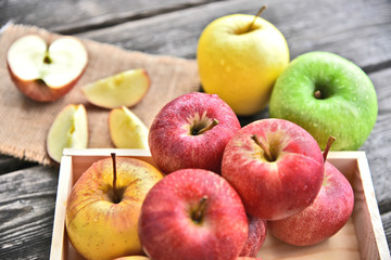 colorful of 3 Type of apple,Gala,Granny Smith,Golden Delicious in wooden box and wooden background.