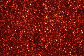 red Sparkling Lights Festive background with texture. Abstract Christmas twinkled bright bokeh defocused and Falling stars. Winter Card or invitation	