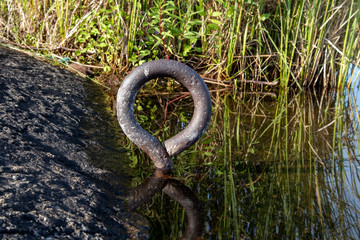 old mooring ring on shore