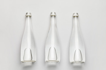 Bottles of clean water on light background