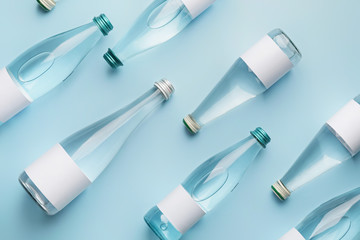 Bottles of clean water on color background