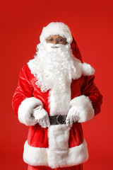 African-American Santa Claus on color background