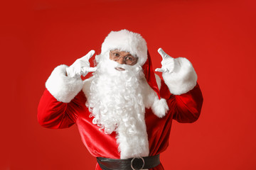 Cool African-American Santa Claus on color background