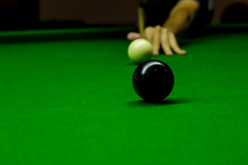 Man playing snooker balls on green snooker table