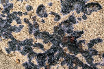 Charred patterns on a stone wall. The concept of exposing a stone surface to high temperatures.