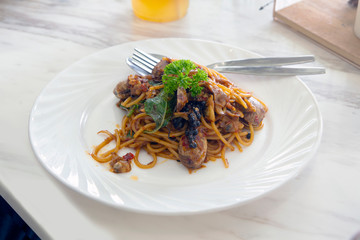 Delicious asian style spaghetti is served on able..