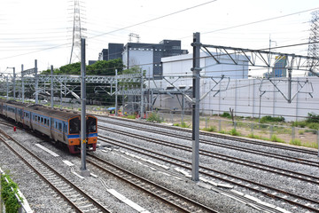 Fototapeta premium Trains running on the train tracks to the station in Thailand. Select focus with shallow depth of field.