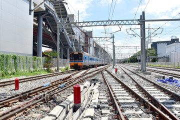 Naklejka premium Trains running on the train tracks to the station in Thailand. Select focus with shallow depth of field.