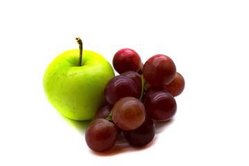 A bunch of grapes and a green Apple