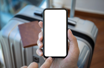 male hand holding phone with isolated screen background of luggage