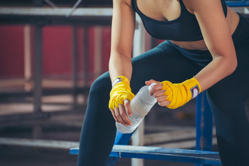 Muay Thai woman and Healthy concept. Boxer drink water during exercise break. Boxing Women prepare...