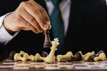 businessman hand moving chess figure in competition success play. strategy,leader and teamwork...