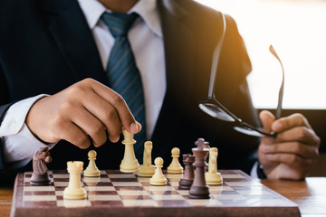 businessman hand moving chess figure in competition success play. strategy,leader and teamwork...