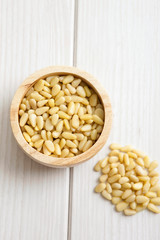 pine nuts in wooden bowl