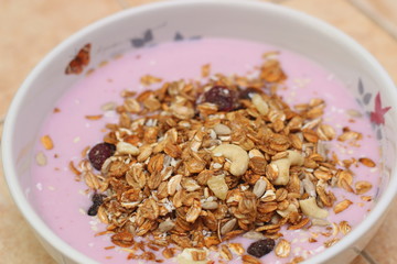 Healthy breakfast. Nuts, cereals, seeds, raisins, candied fruits and milk yogurt