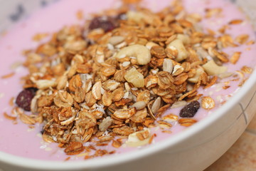 Healthy breakfast. Nuts, cereals, seeds, raisins, candied fruits and milk yogurt