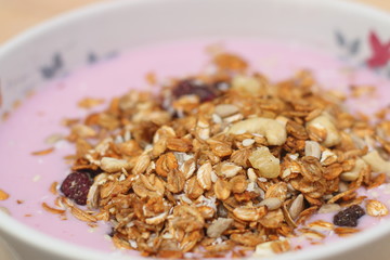 Healthy breakfast. Nuts, cereals, seeds, raisins, candied fruits and milk yogurt
